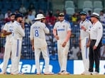 An umpire talks with Indian players before the play stops due to bad light on the third day. An umpire talks with Indian players before the play stops due to bad light on the third day.