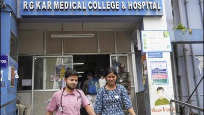 Junior doctors come out of the trauma centre at RG Kar Medical College and Hospital after they rejoined their duty partially in Kolkata on Saturday. (PTI) Junior doctors come out of the trauma centre at RG Kar Medical College and Hospital after they rejoined their duty partially in Kolkata on Saturday. (PTI)