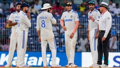 An umpire talks with Indian players before the play stops due to bad light on the third day. (PTI) An umpire talks with Indian players before the play stops due to bad light on the third day. (PTI)