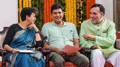 Delhi CM Atishi with fellow AAP leaders and ministers Saurabh Bharadwaj and Gopal Rai during her swearing-in ceremony, at Raj Niwas, in New Delhi, Saturday, Sept. 21, 2024. (PTI Photo/Kamal Singh) Delhi CM Atishi with fellow AAP leaders and ministers Saurabh Bharadwaj and Gopal Rai during her swearing-in ceremony, at Raj Niwas, in New Delhi, Saturday, Sept. 21, 2024. (PTI Photo/Kamal Singh)