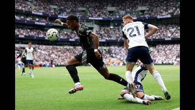 Tottenham Hotspur’s Pedro Porro takes a tumble after his shin meets the boot of Arsenal defender Jurrien Timber (at left). (AFP) Tottenham Hotspur’s Pedro Porro takes a tumble after his shin meets the boot of Arsenal defender Jurrien Timber (at left). (AFP)