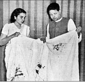 Devadas Gandhi and a compatriot hold up Mahatma Gandhi’s bloodstained dhoti. (Memories of Bapu)