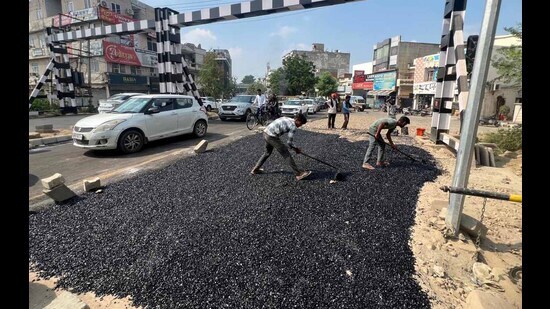Road repair underway near Ishmeet Chowk railway crossing in Ludhiana on Saturday. (Manish/Hindustan Times)