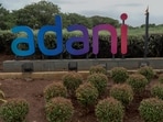 An Adani group sign stands outside Chatrapati Shivaji Mumbai International Airport in Mumbai on July 28, 2021. 