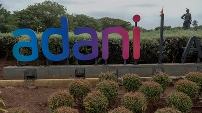 An Adani group sign stands outside Chatrapati Shivaji Mumbai International Airport in Mumbai on July 28, 2021. (Indranil Mukherjee/AFP)