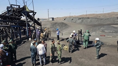Miners and police officers gather around the site of a coal mine where methane leak sparked an explosion on Saturday, in Tabas, some 335 miles (540 kilometers) southeast of the capital Tehran, Iran, Sunday, Sept. 22, 2024. (AP) Miners and police officers gather around the site of a coal mine where methane leak sparked an explosion on Saturday, in Tabas, some 335 miles (540 kilometers) southeast of the capital Tehran, Iran, Sunday, Sept. 22, 2024. (AP)