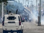 Security personnel fire tear gas shells to disperse protesters during a curfew in Imphal on September 10. (AFP) Security personnel fire tear gas shells to disperse protesters during a curfew in Imphal on September 10. (AFP)