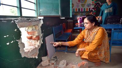 A teacher points to the hole in the wall on Monday. School authorities said thieves have been repeatedly striking at the school, since the past several years. and police are yet to act on their complaints. (Sakib Ali/HT Photo) A teacher points to the hole in the wall on Monday. School authorities said thieves have been repeatedly striking at the school, since the past several years. and police are yet to act on their complaints. (Sakib Ali/HT Photo)
