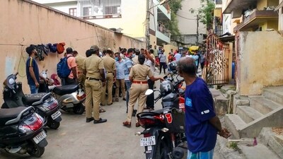 Bengaluru: Police and locals near the crime scene after a woman was allegedly murdered in Malleswaram. (PTI) Bengaluru: Police and locals near the crime scene after a woman was allegedly murdered in Malleswaram. (PTI)