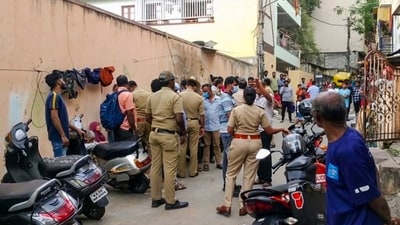 Bengaluru: Police and locals near the crime scene after a woman was allegedly murdered in Malleswaram. (PTI)
