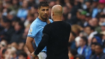 Manchester City's Rodri with manager Pep Guardiola. (REUTERS)