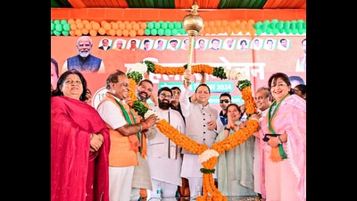 Uttarakhand chief minister Pushkar Singh Dhami holding a mace during 'Women's Conference' in support of Bharatiya Janata Party (BJP) Kalka candidate Shakti Rani Sharma for the upcoming Haryana assembly elections at Pinjore in Panchkula on Monday. (ANI)