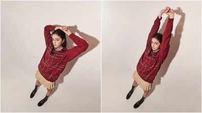 Ananya accessorised the ensemble with olive green calf-length socks, black chunky loafers, and statement earrings. She tied her long tresses in a half-tied hairdo. Ananya accessorised the ensemble with olive green calf-length socks, black chunky loafers, and statement earrings. She tied her long tresses in a half-tied hairdo. 