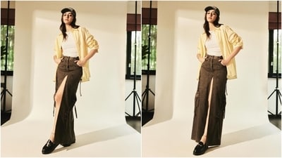 In this second look, Ananya embraced neutral tones. The fall-ready outfit features a white round-neck tank top, a pinstriped yellow shirt, and a faded brown denim skirt featuring a risque thigh-high slit on the front. In this second look, Ananya embraced neutral tones. The fall-ready outfit features a white round-neck tank top, a pinstriped yellow shirt, and a faded brown denim skirt featuring a risque thigh-high slit on the front. 