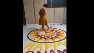 The woman can be heard speaking in Malayalam as she stands on the Onam Pookalam. (X)