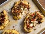 This image released by Milk Street shows a recipe for cauliflower steaks with pickled peppers, capers and parmesan. (Milk Street via AP)