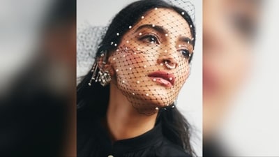 She accessorised her look with a pair of chunky silver statement earrings, a septum nose ring, and a black netted mask adorned with pearls, adding an extra dose of glamour. (Instagram/@rheakapoor)