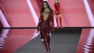 Anitta makes heads turn in a sheer wine-red, open-front shirt styled with a matching thigh-slit leather skirt and a bare-there bikini top. She completed the look with heeled thigh-high boots, silver hoop earrings, and striking glam. (AFP) Anitta makes heads turn in a sheer wine-red, open-front shirt styled with a matching thigh-slit leather skirt and a bare-there bikini top. She completed the look with heeled thigh-high boots, silver hoop earrings, and striking glam. (AFP)