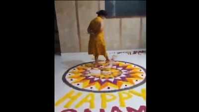 The woman can be heard speaking in Malayalam as she stands on the Onam Pookalam. (X) The woman can be heard speaking in Malayalam as she stands on the Onam Pookalam. (X)