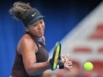 Japan's Naomi Osaka hits a return against Italy's Lucia Bronzetti during their women's singles match at the China Open tennis tournament in Beijing.
