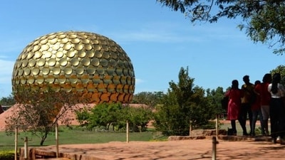 Visitors stand near the Matri Mandir, an edifice of spiritual significance for practitioners of integral yoga, in Auroville near Pondicherry on April 9, 2022. (Photo by Arun SANKAR / AFP) (AFP) Visitors stand near the Matri Mandir, an edifice of spiritual significance for practitioners of integral yoga, in Auroville near Pondicherry on April 9, 2022. (Photo by Arun SANKAR / AFP) (AFP)