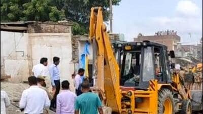 A bulldozer in action in Kaiserganj tehsil of Bahraich on Wednesday. (SOURCED IMAGE )