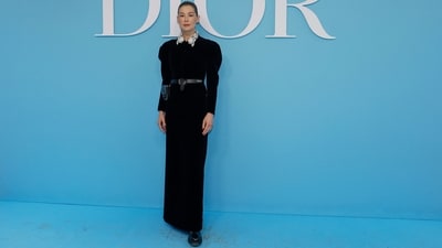 Rosamund Pike poses on the blue carpet at the Christian Dior Women Ready-to-wear Spring-Summer 2025 show in a black floor-length dress featuring a printed collar, puffed shoulders, a cinched waist accessorised with a belt, and a figure-hugging fit. She wore the ensemble with black boots, minimal glam, and a pulled-back bun. (AFP) Rosamund Pike poses on the blue carpet at the Christian Dior Women Ready-to-wear Spring-Summer 2025 show in a black floor-length dress featuring a printed collar, puffed shoulders, a cinched waist accessorised with a belt, and a figure-hugging fit. She wore the ensemble with black boots, minimal glam, and a pulled-back bun. (AFP)