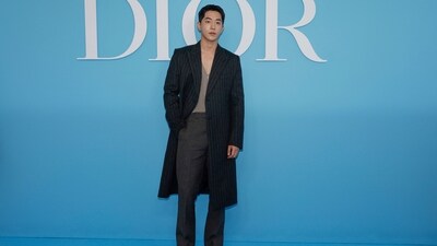 Twenty-Five Twenty-One actor Nam Joo-hyuk arrived at the Dior Spring Summer 2025 show in a V-neck beige sweater vest styled with grey high-waisted pants and a pinstripe printed trench coat. He chose black leather Chelsea boots to style the ensemble. (AFP) Twenty-Five Twenty-One actor Nam Joo-hyuk arrived at the Dior Spring Summer 2025 show in a V-neck beige sweater vest styled with grey high-waisted pants and a pinstripe printed trench coat. He chose black leather Chelsea boots to style the ensemble. (AFP)