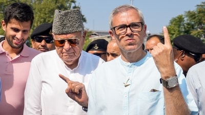Srinagar: Jammu and Kashmir National Conference (JKNC) President Farooq Abdullah and Vice President Omar Abdullah show their fingers marked with indelible ink after casting vote during the second phase of Jammu and Kashmir Assembly elections, in Srinagar, Wednesday. (PTI) Srinagar: Jammu and Kashmir National Conference (JKNC) President Farooq Abdullah and Vice President Omar Abdullah show their fingers marked with indelible ink after casting vote during the second phase of Jammu and Kashmir Assembly elections, in Srinagar, Wednesday. (PTI)