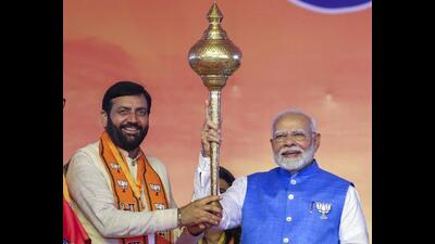 Prime Minister Narendra Modi being presented a mace by Haryana CM Nayab Singh Saini during a public meeting at Gohana in Sonepat district of Haryana on Wednesday. (PTI Photo)