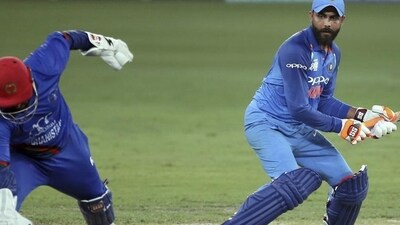 Ravindra Jadeja attempts a run as Afghanistan's wicketkeeper Mohammad Shahzad (left) runs to field the ball in a 2018 Asia Cup match. (AP Photo) Ravindra Jadeja attempts a run as Afghanistan's wicketkeeper Mohammad Shahzad (left) runs to field the ball in a 2018 Asia Cup match. (AP Photo)