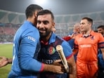 Afghanistan's skipper Hashmatullah Shahidi being congratulated by team members and staff after winning the match against Netherlands in the ICC Men's Cricket World Cup 2023