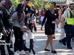 A video showing the woman being dragged out of Disneyland while her daughters cling to her and cry has gone viral on social media.