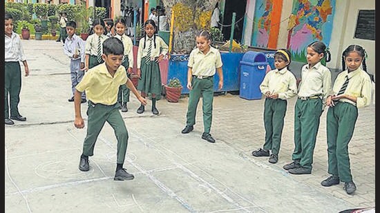 Students of a government school play during games period in Ludhiana on Thursday. (HT Photo)
