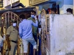 Police personnel investigate after the dead body of a woman, cut into pieces, was found stored in a refrigerator, at Vyalikaval in Bengaluru on Saturday. (ANI Photo)