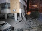 This picture shows damaged cars and buildings following an Israeli air strike in the Haret Hreik neighbourhood of Beirut's southern suburbs on September 27, 2024. Israel carried out air strikes on the south of Lebanon's capital Beirut on September 27 that it said targeted Hezbollah's headquarters. (Photo by AFP)