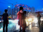 Two school students share an umbrella to shield themselves during rain, in Mumbai, Two school students share an umbrella to shield themselves during rain, in Mumbai,