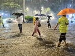 People cross the road while holding umbrellas amid rainfall in Mumbai where heavy rainfall caused waterlogging. (ANI Photo)

