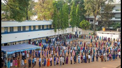 Bengaluru: People wait in queues to cast their votes for the 2nd phase of Lok Sabha polls at a polling station at Rajarajeshwari Nagar, in Bengaluru, Friday, April 26, 2024. (PTI Photo/Shailendra Bhojak) (PTI04_26_2024_000061B) (PTI)