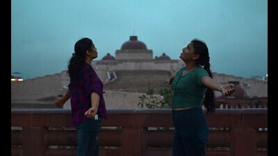 Girls enjoying the rain in Lucknow on Friday. (HT)