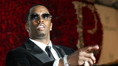 FILE - Sean "P. Diddy" Combs directs photographers as they sing "Happy Birthday," to him as his date Kim Porter, left, listens (AP) FILE - Sean "P. Diddy" Combs directs photographers as they sing "Happy Birthday," to him as his date Kim Porter, left, listens (AP)