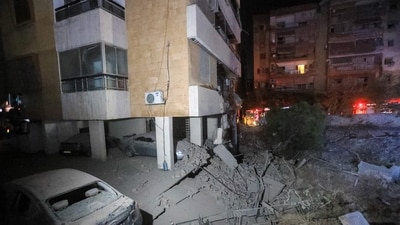 This picture shows damaged cars and buildings following an Israeli air strike in the Haret Hreik neighbourhood of Beirut's southern suburbs on September 27, 2024. Israel carried out air strikes on the south of Lebanon's capital Beirut on September 27 that it said targeted Hezbollah's headquarters. (Photo by AFP) This picture shows damaged cars and buildings following an Israeli air strike in the Haret Hreik neighbourhood of Beirut's southern suburbs on September 27, 2024. Israel carried out air strikes on the south of Lebanon's capital Beirut on September 27 that it said targeted Hezbollah's headquarters. (Photo by AFP)