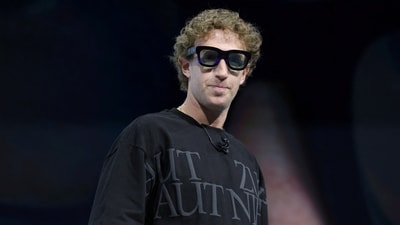 Meta CEO Mark Zuckerberg tries on Orion AR glasses at the Meta Connect annual event. (REUTERS)