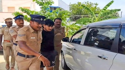 Namakkal: Police personnel take a member of a gang suspected to have been involved in ATM heist in Kerala's Thrissur, after he was injured in police firing, in Namakkal district. (PTI) Namakkal: Police personnel take a member of a gang suspected to have been involved in ATM heist in Kerala's Thrissur, after he was injured in police firing, in Namakkal district. (PTI)