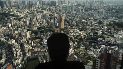 A man watches the cityscape of Tokyo from an observation deck located on the top floor of Roppongi Hills Mori Tower (Jae C. Hong/AP)