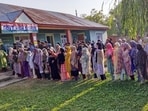 Budgam, Sept 25 (ANI): Voters wait in queues to cast their votes for the second phase of the Jammu and Kashmir Assembly elections, in Budgam on Wednesday. (ANI Photo)