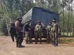 Security personnel stand guard after an encounter broke out between terrorists and security forces during cordon and search operation at Adigam village, in Kulgam district, Saturday, Security personnel stand guard after an encounter broke out between terrorists and security forces during cordon and search operation at Adigam village, in Kulgam district, Saturday,