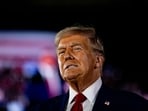 Former US President and Republican presidential nominee Donald Trump smiles as he takes the stage during a Town Hall event at Macomb Community College on September 27, 2024 in Warren, Michigan.