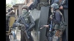 Security men keep vigil during a gunfight in Kulgam on Saturday.
