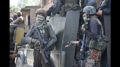Security men keep vigil during a gunfight in Kulgam on Saturday. Security men keep vigil during a gunfight in Kulgam on Saturday.